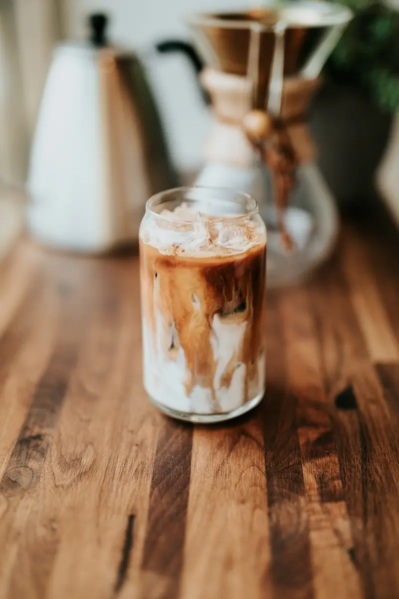 Iced cold brew with milk swirling through the glass
