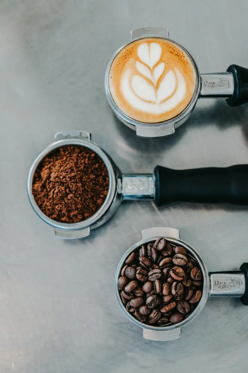 A portafilter of freshly ground coffee on the espresso machine